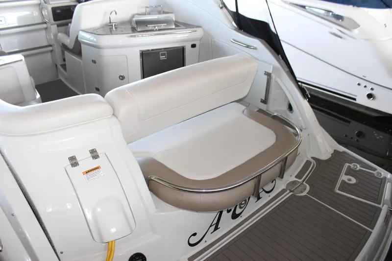 Slide: The Image of 2021 Crownline 294 CR boat interior with seating and kitchenette area. - 10