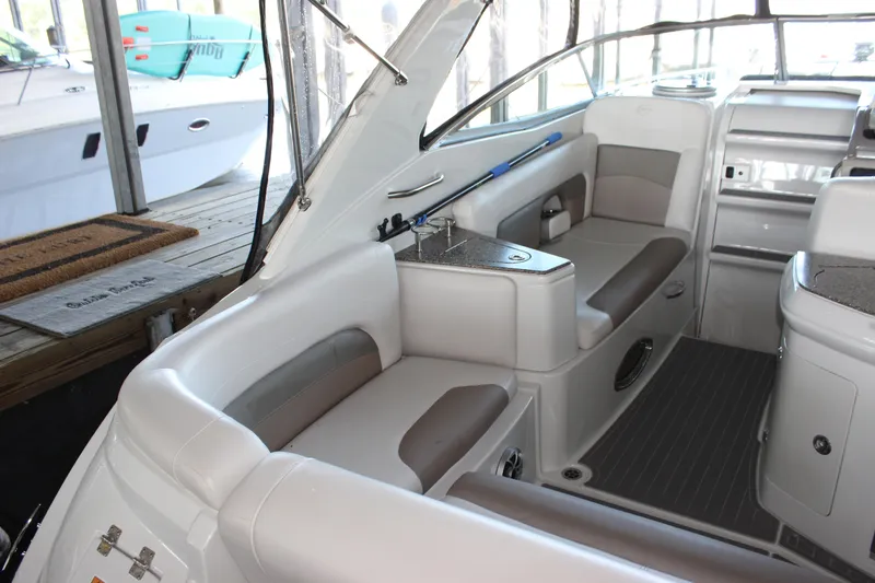 Slide: The Image of 2021 Crownline 294 CR boat interior with white seating and modern amenities. - 12