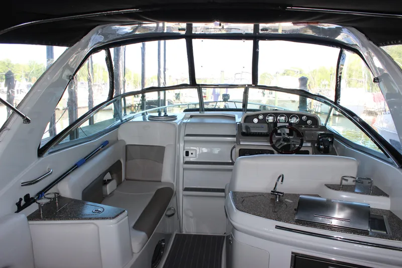 Slide: The Image of 2021 Crownline 294 CR boat interior with modern helm and seating area. - 14