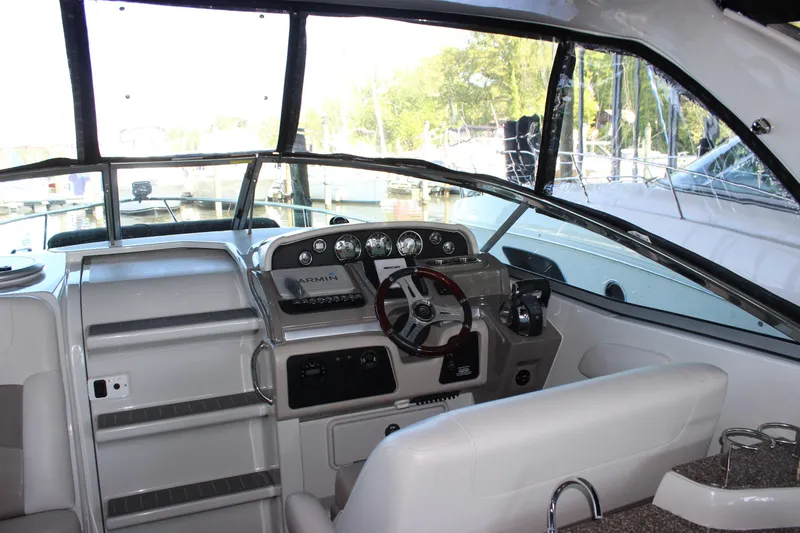 Slide: The Image of 2021 Crownline 294 CR boat interior with modern dashboard and steering wheel. - 16
