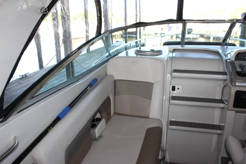 Slide: The Image of 2021 Crownline 294 CR boat interior with seating and helm, showcasing modern design. - 17