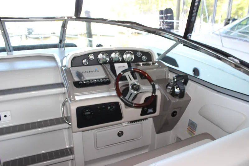 Slide: The Image of 2021 Crownline 294 CR boat dashboard with steering wheel and control panel. - 18