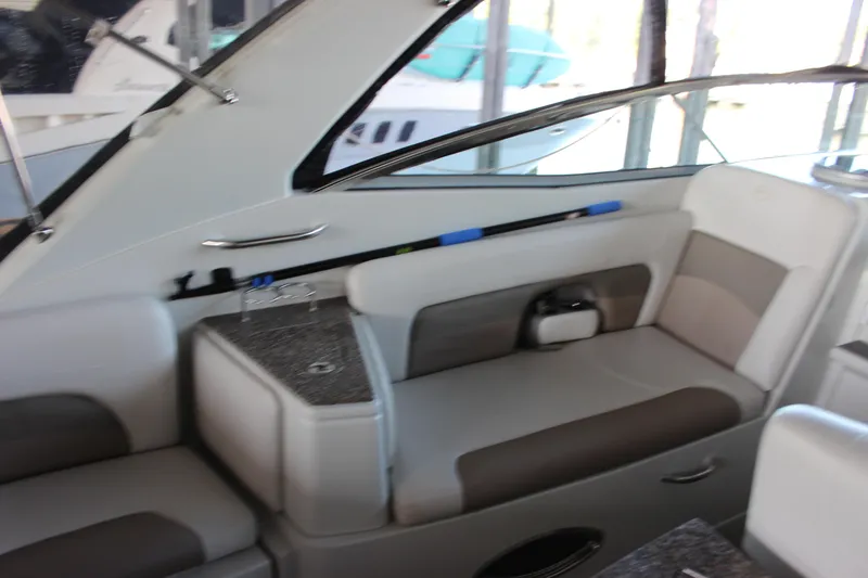 Slide: The Image of 2021 Crownline 294 CR boat interior with beige seating and sleek design. - 19