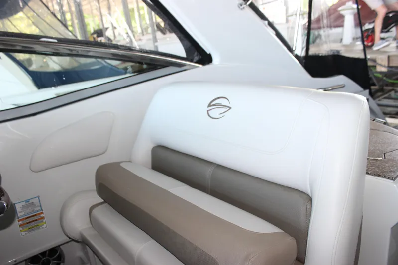 Slide: The Image of 2021 Crownline 294 CR boat interior with white and beige seating. - 23