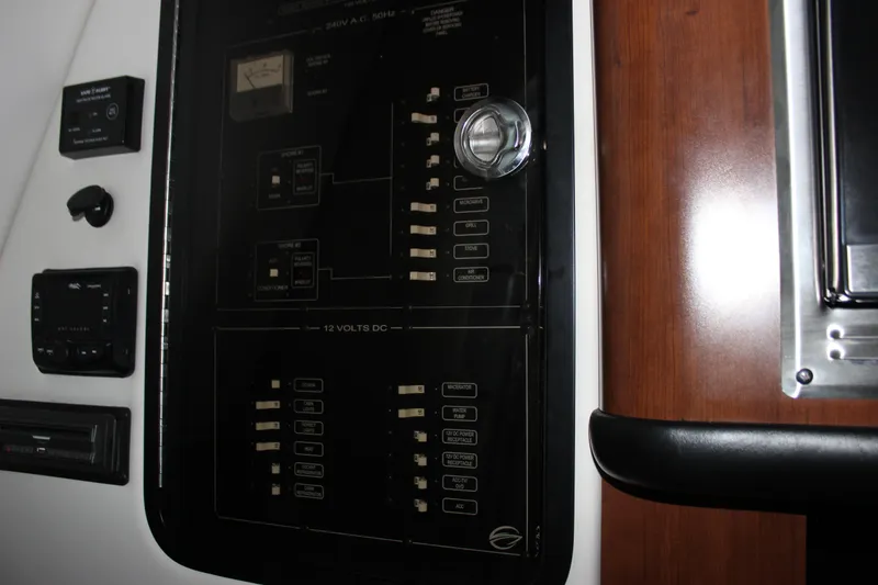 Slide: The Image of Electrical panel inside a 2021 Crownline 294 CR boat, featuring various switches and controls. - 30