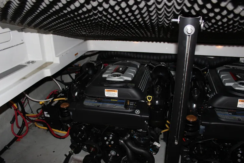 Slide: The Image of Engine compartment of a 2021 Crownline 294 CR boat, featuring dual engines. - 32