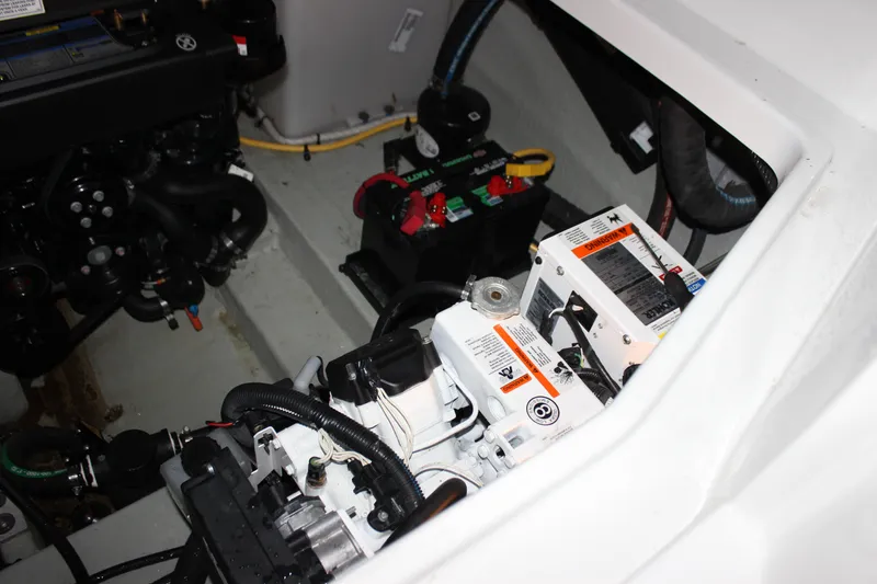 Slide: The Image of Engine compartment of a 2021 Crownline 294 CR boat, showcasing mechanical components and wiring. - 34