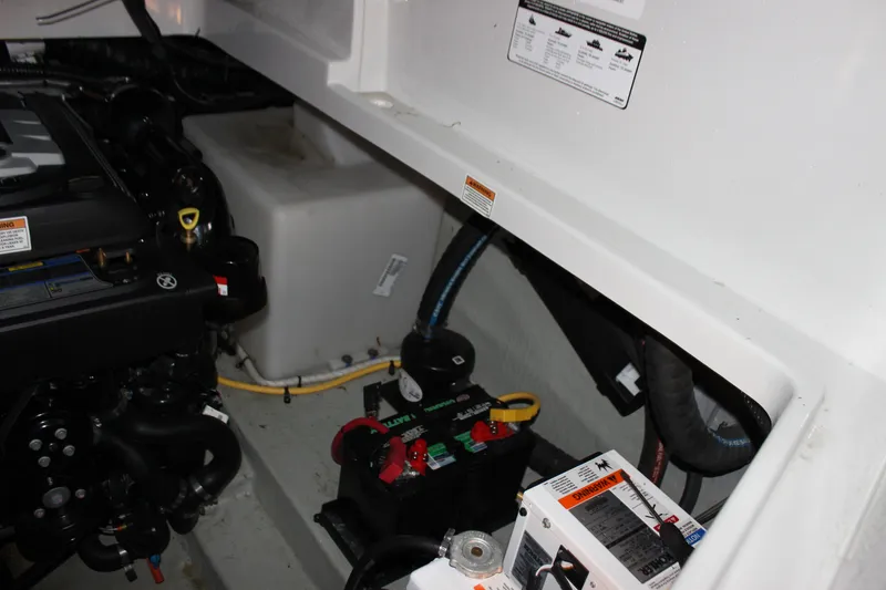 Slide: The Image of Engine compartment of 2021 Crownline 294 CR boat, showing battery and wiring components. - 35