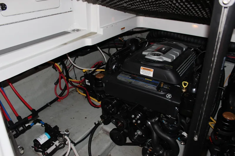 Slide: The Image of Engine compartment of 2021 Crownline 294 CR boat, showcasing wiring and mechanical components. - 36