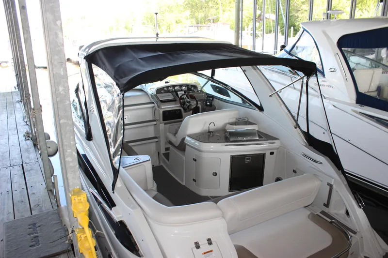 Slide: The Image of 2021 Crownline 294 CR boat with canopy, docked in a marina. - 37