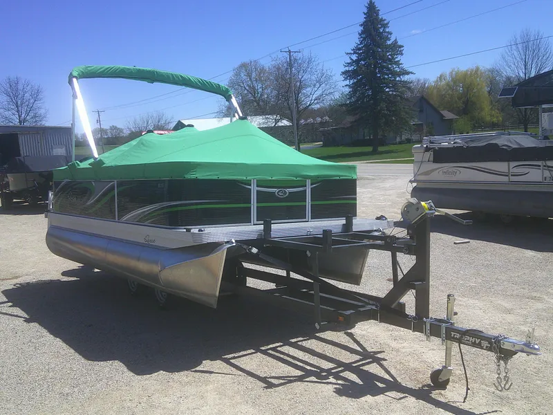 Slide: The Image of 2022 Qwest 816 Edge 4 Point Fish pontoon boat with green canopy on trailer. - 20