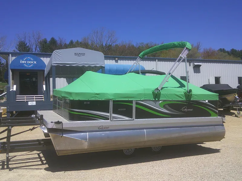 Slide: The Image of 2022 Qwest 816 Edge 4 Point Fish pontoon boat with green cover at dry dock. - 21
