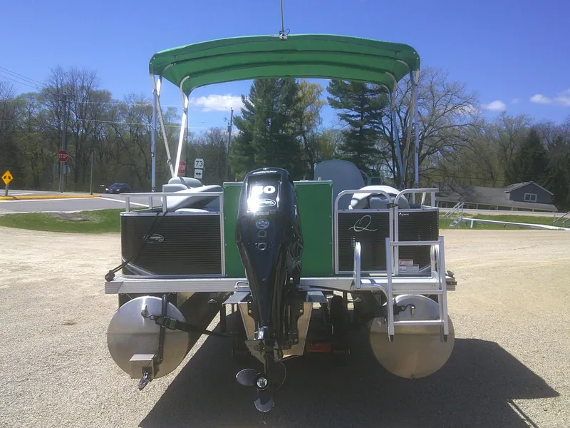 Slide: The Image of 2022 Qwest 816 Edge 4 Point Fish pontoon boat with green canopy, parked on gravel. - 3