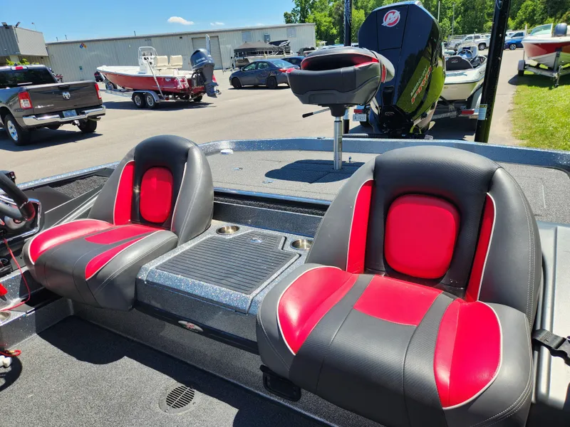 Slide: The Image of 2022 Ranger Z519 boat interior with red and black seats, parked outdoors. - 10