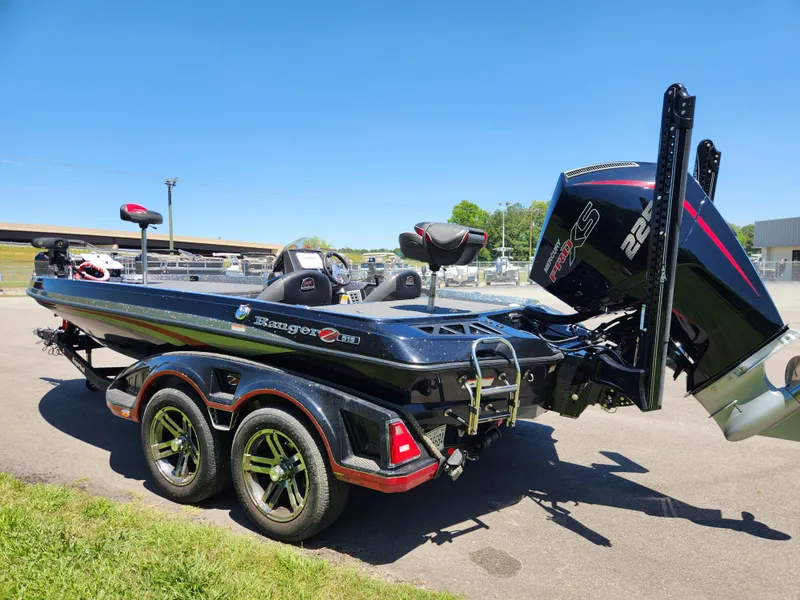 Slide: The Image of 2022 Ranger Z519 boat with dual axle trailer, parked outdoors on a sunny day. - 4