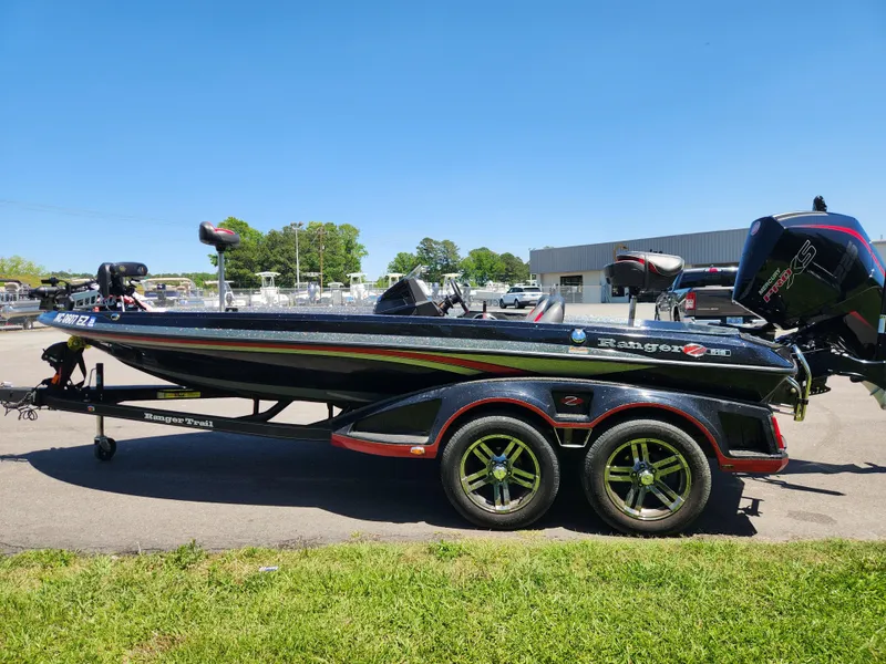 Slide: The Image of 2022 Ranger Z519 boat on trailer, parked outdoors under clear blue sky. - 5