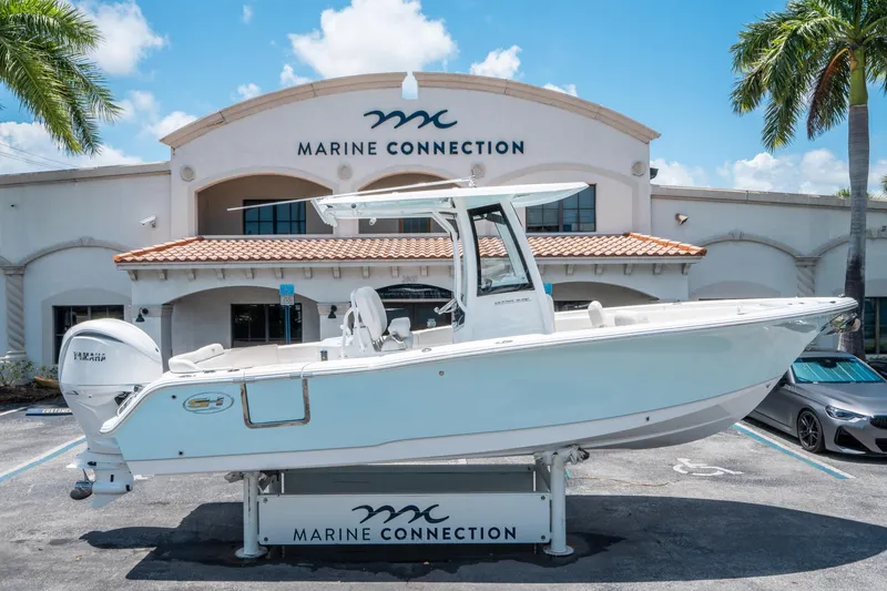 Slide: The Image of 2025 Sea Hunt Ultra 245 SE boat displayed at Marine Connection dealership. - 1