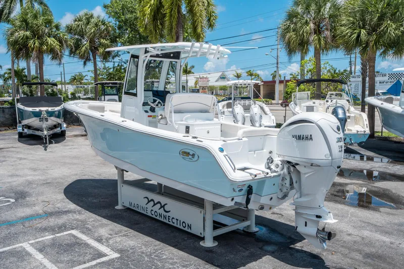 Slide: The Image of 2025 Sea Hunt Ultra 245 SE boat with Yamaha engine displayed outdoors. - 4
