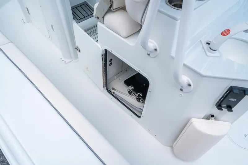 Slide: The Image of 2025 Sea Hunt Ultra 245 SE boat storage compartment with open hatch. - 17