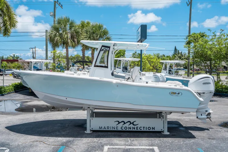 Slide: The Image of 2025 Sea Hunt Ultra 245 SE boat displayed outdoors on a sunny day. - 5