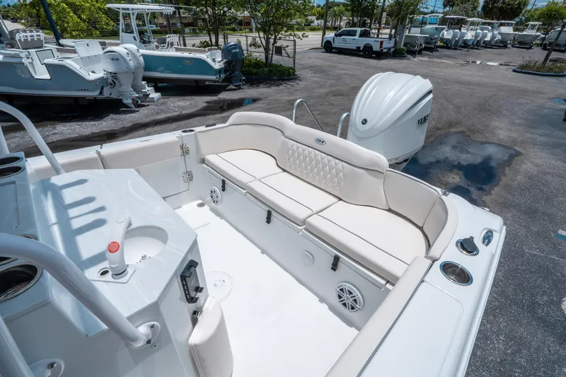 Slide: The Image of 2025 Sea Hunt Ultra 245 SE boat interior with white seating and Yamaha outboard motor. - 12