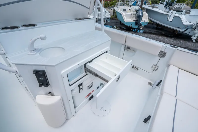 Slide: The Image of 2025 Sea Hunt Ultra 245 SE boat interior with storage and seating. - 16