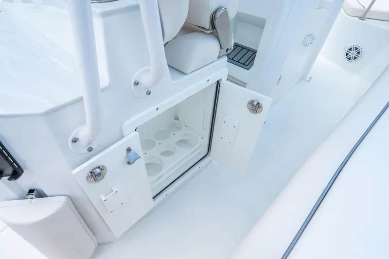 Slide: The Image of 2025 Sea Hunt Ultra 245 SE boat interior with open storage compartment. - 18