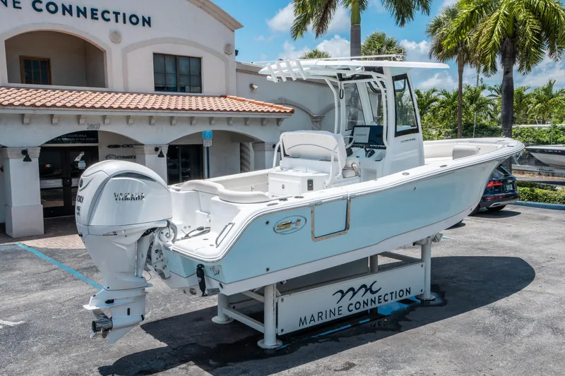 Slide: The Image of 2025 Sea Hunt Ultra 245 SE boat displayed at Marine Connection dealership. - 2