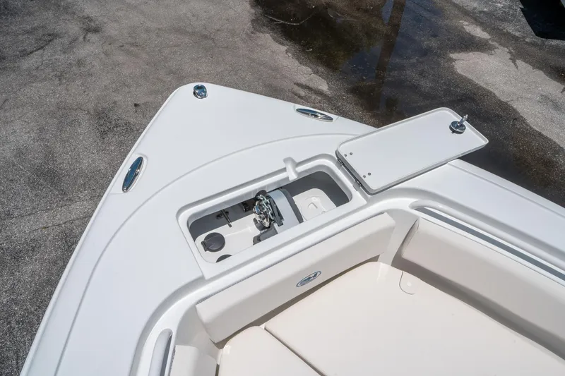 Slide: The Image of 2025 Sea Hunt Ultra 245 SE boat bow with storage compartment and sleek design. - 32