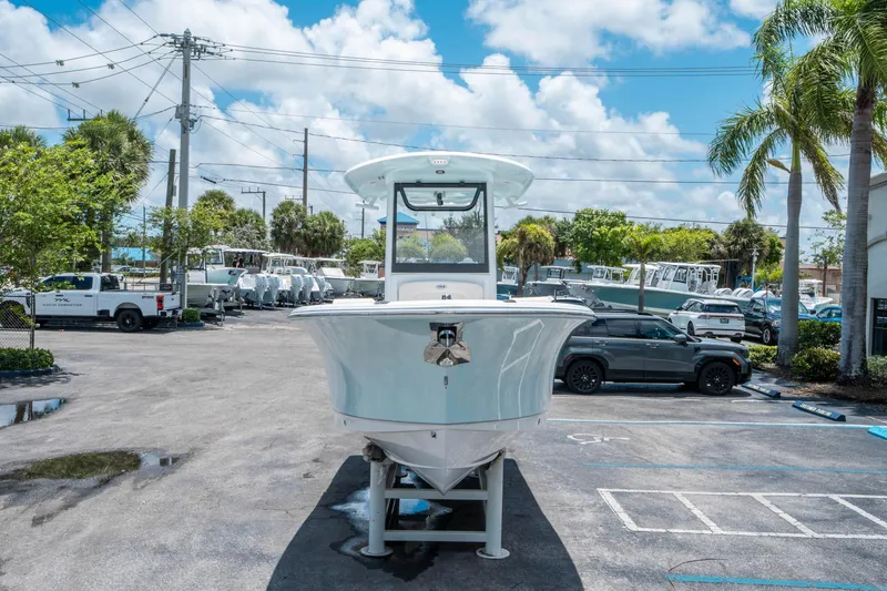 Slide: The Image of 2025 Sea Hunt Ultra 245 SE boat displayed in a sunny parking lot. - 7