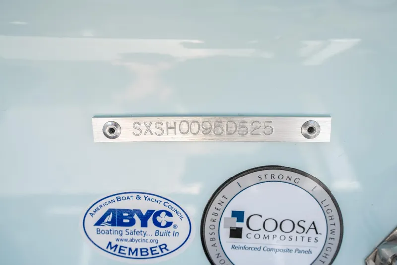 Slide: The Image of 2025 Sea Hunt Ultra 245 SE boat identification plate with ABYC and Coosa Composites logos. - 34
