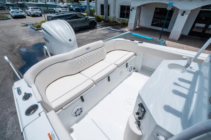 Slide: The Image of 2025 Sea Hunt Ultra 245 SE boat interior with white seating and Yamaha engine. - 11