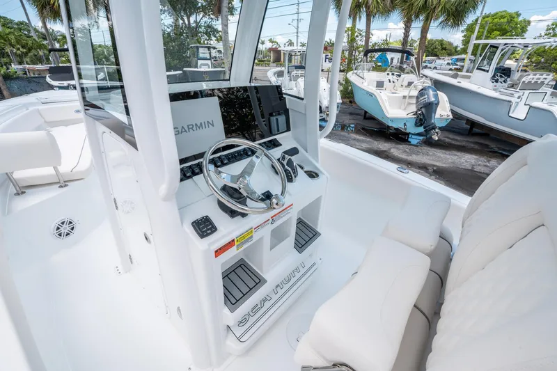 Slide: The Image of 2025 Sea Hunt Ultra 245 SE boat interior with Garmin navigation system and sleek steering console. - 20