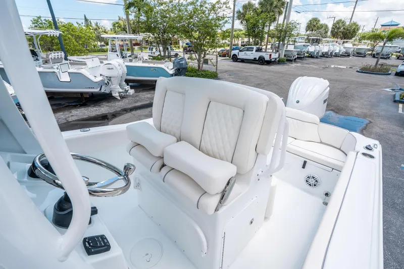 Slide: The Image of 2025 Sea Hunt Ultra 245 SE boat interior with white seating and steering wheel. - 22