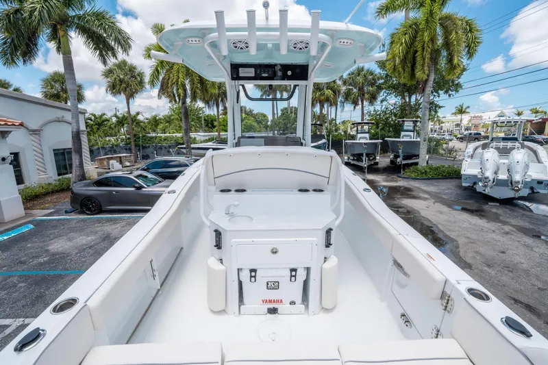 Slide: The Image of 2025 Sea Hunt Ultra 245 SE boat interior with Yamaha engine, parked outdoors. - 9