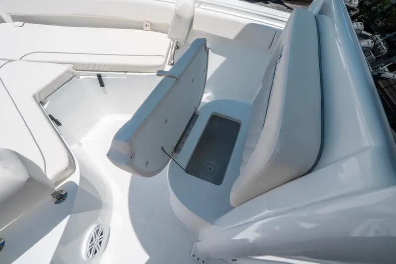 Slide: The Image of 2025 Sea Hunt Ultra 245 SE boat interior with open storage compartment and seating. - 31