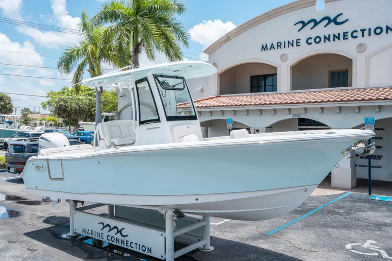 Slide: The Image of 2025 Sea Hunt Ultra 245 SE boat displayed at Marine Connection dealership. - 8