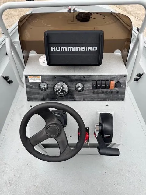 Slide: The Image of 2023 Polar Kraft 190 Sport X boat dashboard with steering wheel and Humminbird fish finder. - 12