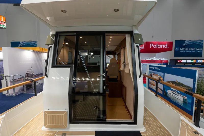 Slide: The Image of 2026 Targa 27 boat interior at a motor boat exhibition, showcasing sleek design and modern features. - 13