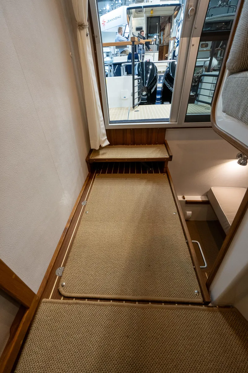 Slide: The Image of Interior view of 2026 Targa 27 boat with carpeted flooring and window. - 14