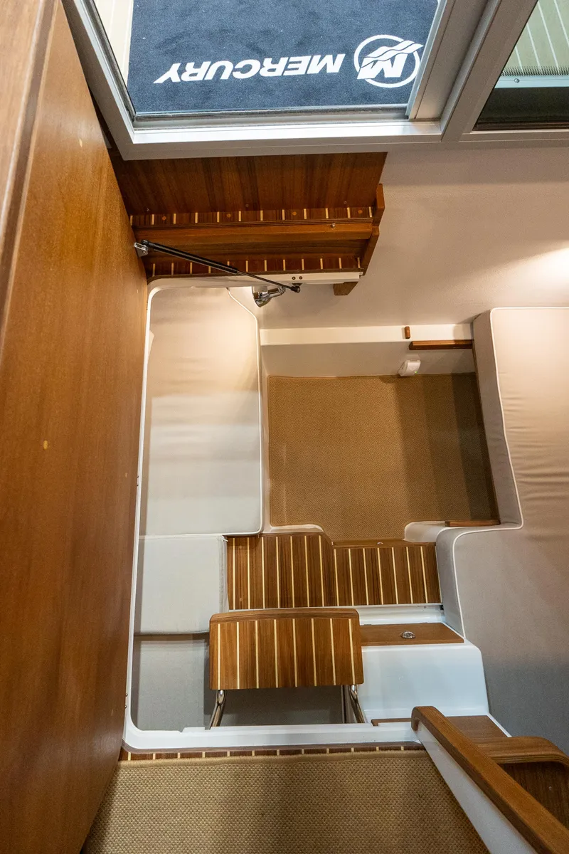 Slide: The Image of Interior view of 2026 Targa 27 boat with wooden stairs and seating area. - 15