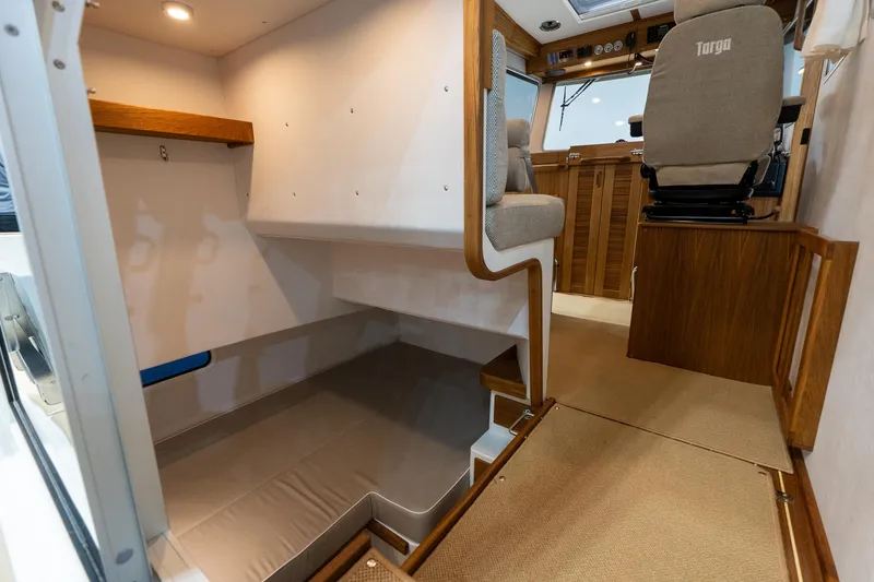 Slide: The Image of Interior of 2026 Targa 27 boat, featuring seating and sleeping area. - 18
