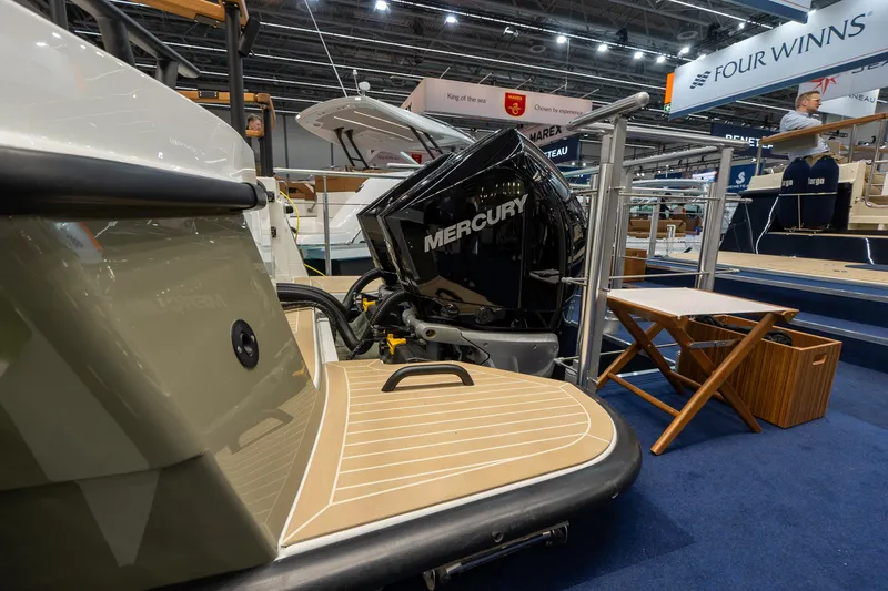 Slide: The Image of 2026 Targa 27 boat with Mercury engine displayed at a boat show. - 2