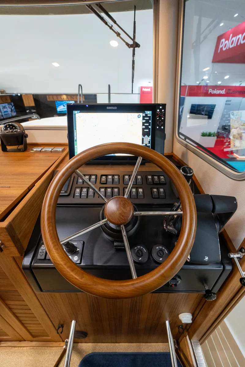 Slide: The Image of Steering wheel and control panel of a 2026 Targa 27 boat interior. - 22