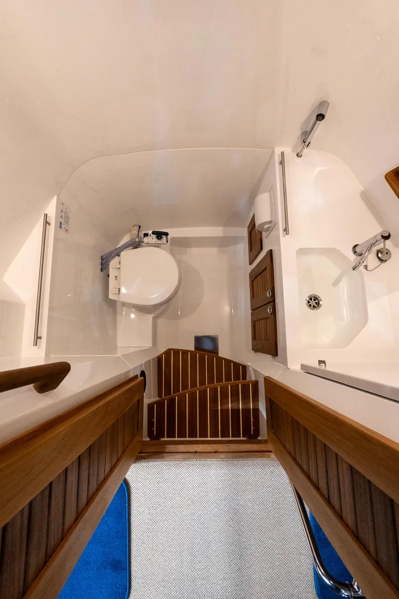 Slide: The Image of Interior of 2026 Targa 27 boat bathroom with wooden accents and modern fixtures. - 23