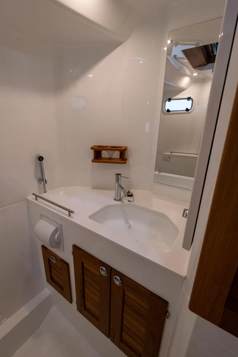 Slide: The Image of Modern bathroom in 2026 Targa 27 boat with sleek sink and wooden cabinets. - 24