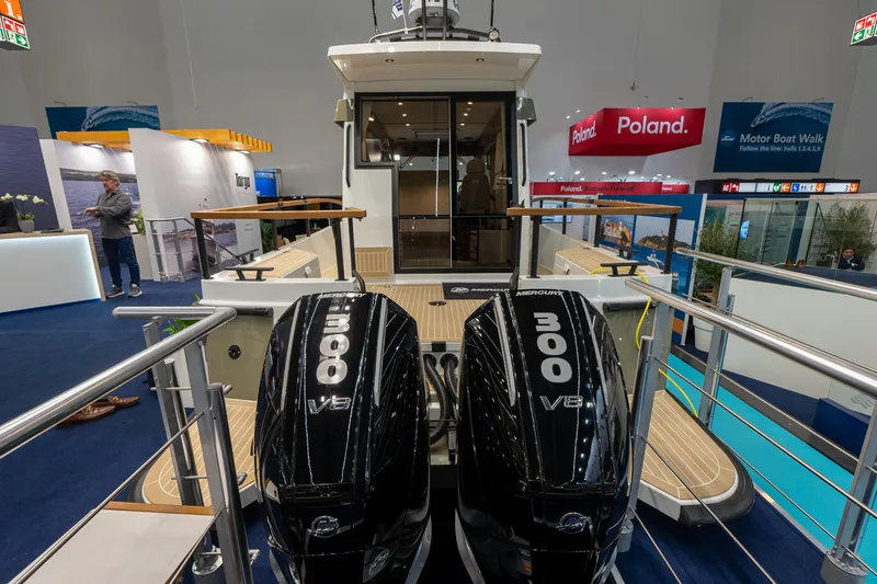 Slide: The Image of 2026 Targa 27 boat with dual 300 V8 engines displayed at a boat show. - 3