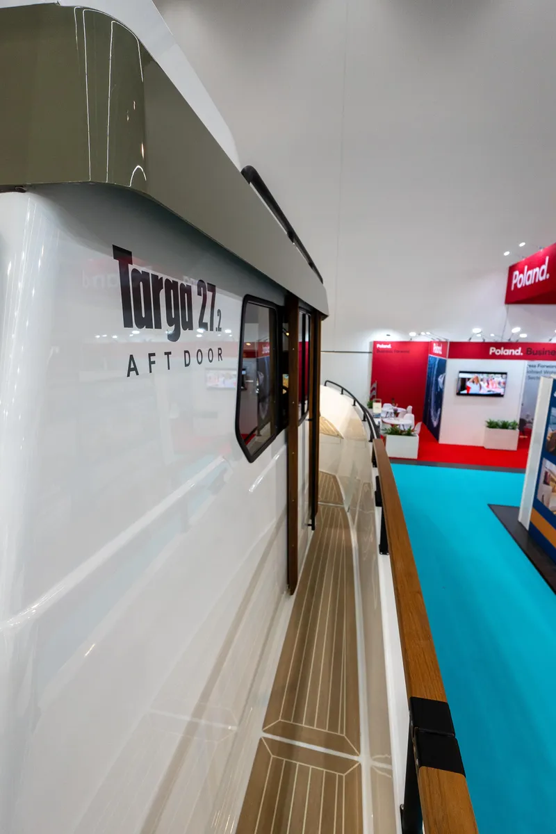 Slide: The Image of 2026 Targa 27 boat at indoor exhibition, showcasing sleek design and modern features. - 6