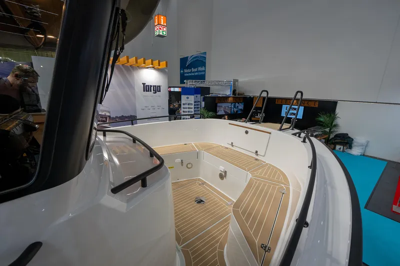 Slide: The Image of 2026 Targa 27 boat interior at a showroom, featuring sleek design and wooden flooring. - 7