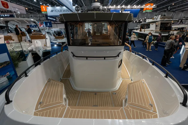 Slide: The Image of Targa 27 boat, 2026 model, showcased at a boat exhibition with wooden deck and cabin. - 9